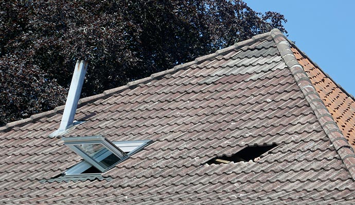 after a storm roof hole damage repair of a house