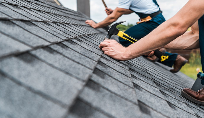repairing roof with coworker