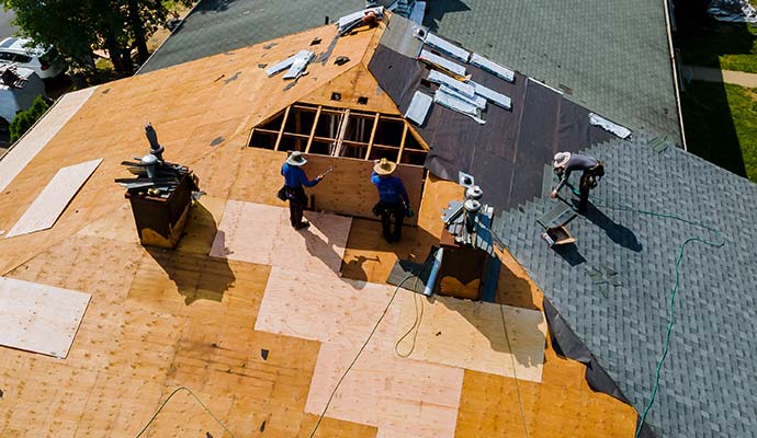 worker on renovation roof of a house re-roofinging