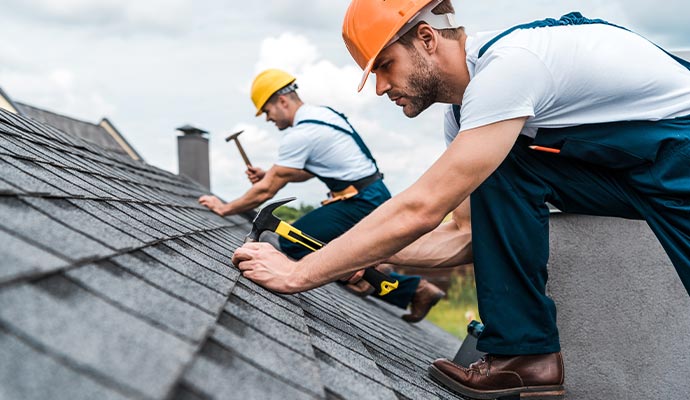 Worker repairing roof and maintaining